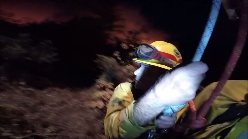 Dramatic helicopter rescue of firefighters trapped by California wildfire