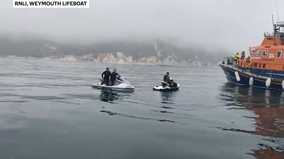Dolphins play with Weymouth lifeboat crew
