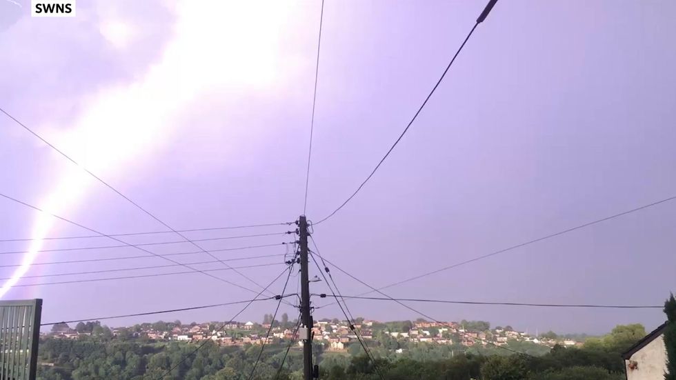 Lightning bolt strikes down curvature of rainbow in stunning video