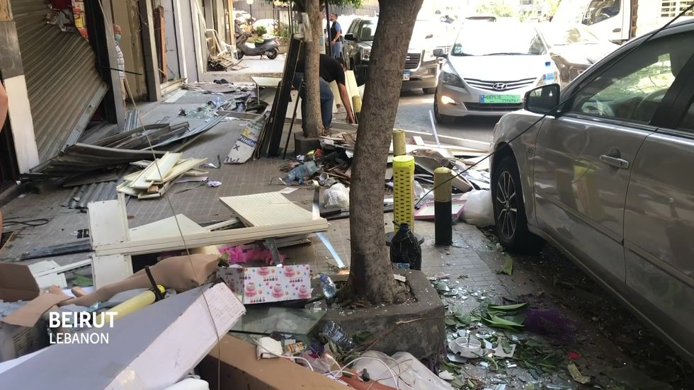Shattered glass and debris in devastated Beirut street