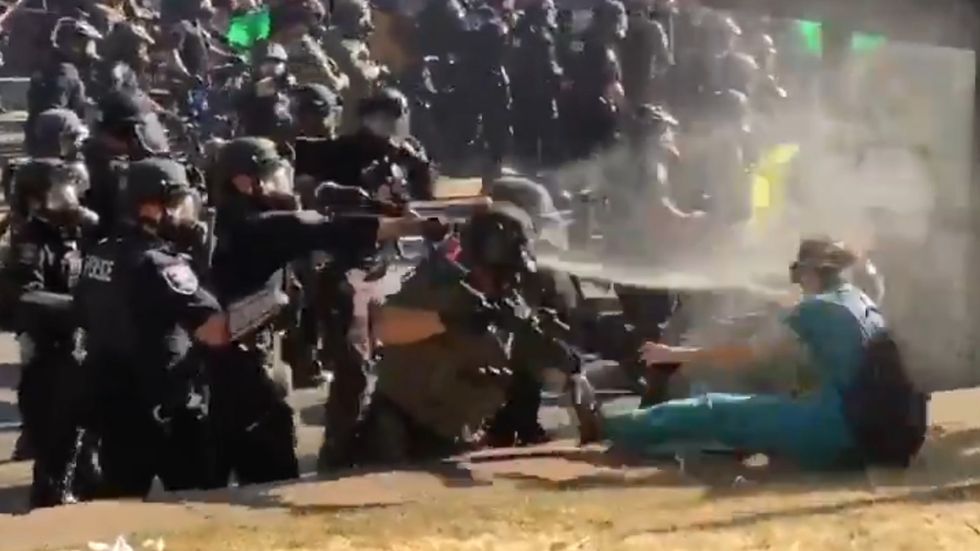 Nurse wearing scrubs pepper sprayed by police in Seattle