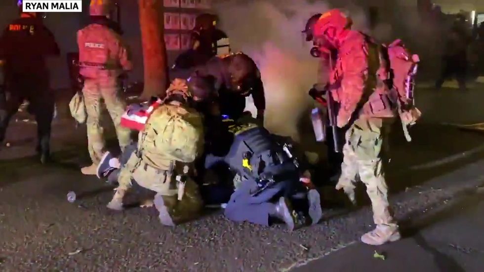 Protester with American flag tackled by federal police in Portland