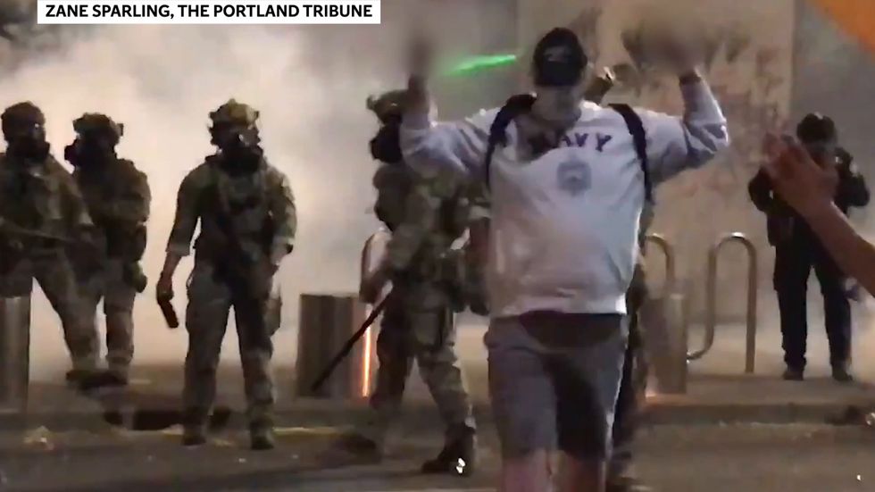 Federal officers are filmed hitting a Portland protester with batons and spraying him with pepper spray