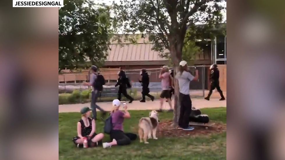 Heavily armed riot police break up peaceful violin vigil for young black man killed by fellow officers