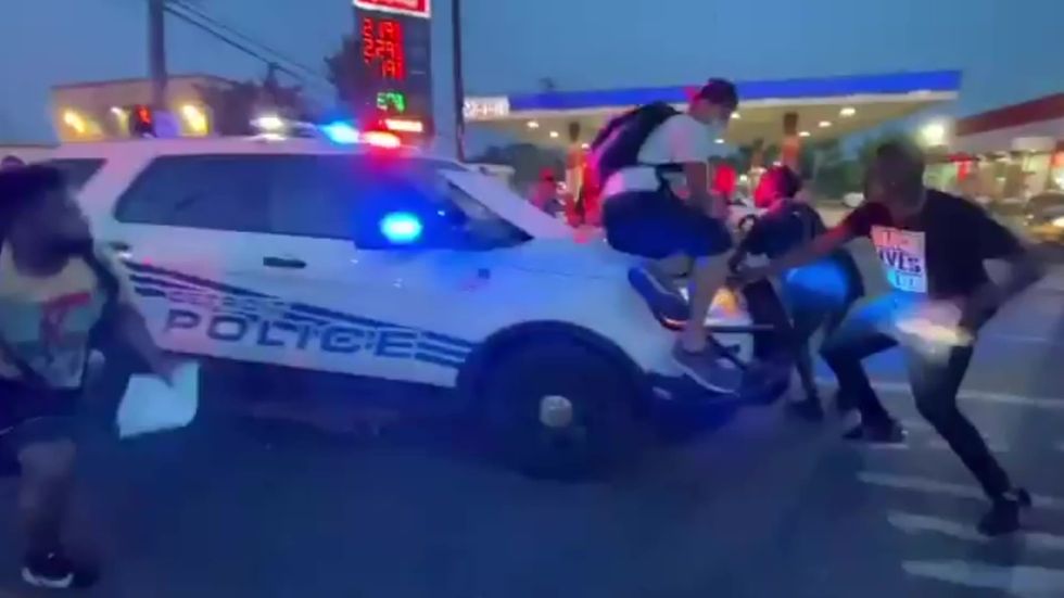 Detroit police ram protesters with car