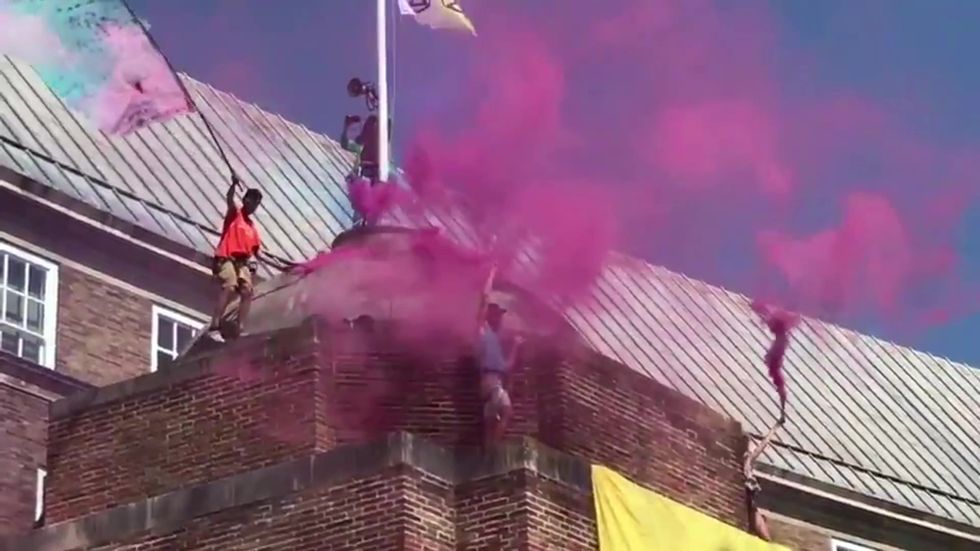 Extinction Rebellion protesters scale Bristol city hall and release smoke bombs on roof