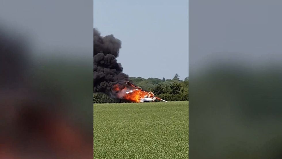 Helicopter bursts into flames after crashing in a Warwickshire field