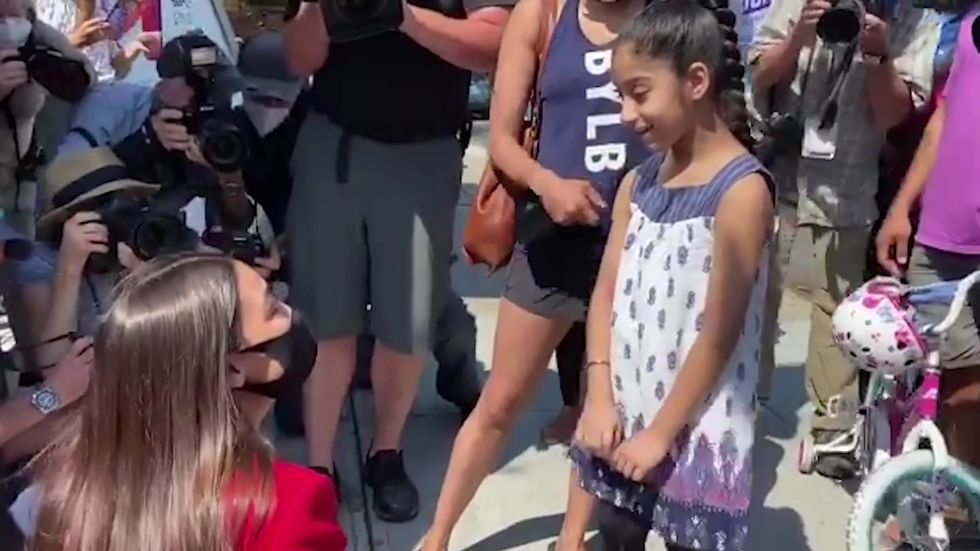 Alexandria Ocasio-Cortez meets young girl on the campaign trail in Queens