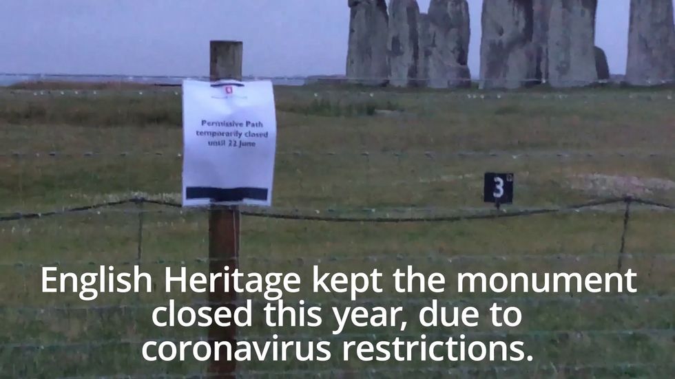A cloudy Stonehenge welcomes dawn after summer solstice