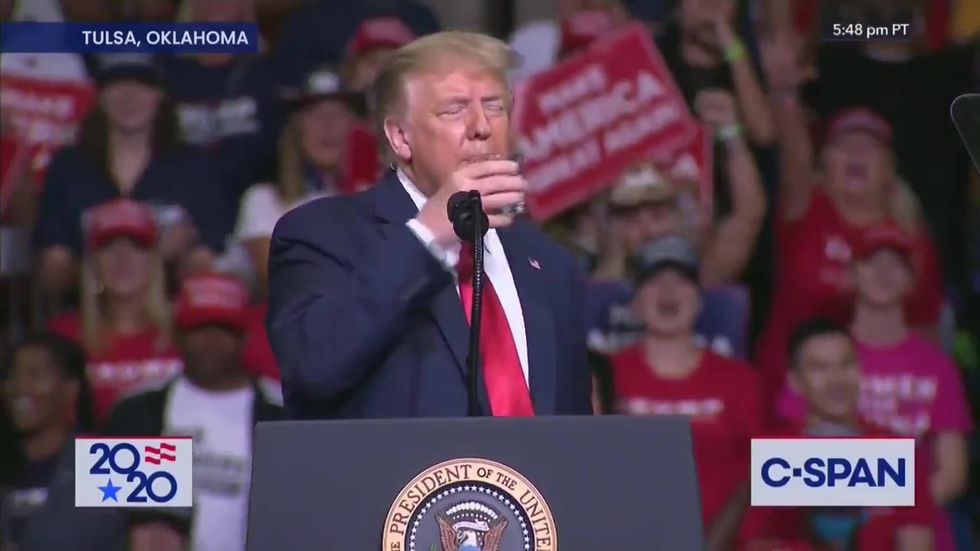 Crowd goes wild as Donald Trump successfully drinks a glass of water