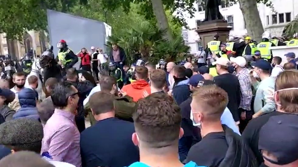 Police on horseback with shields and helmets at rival demonstrations