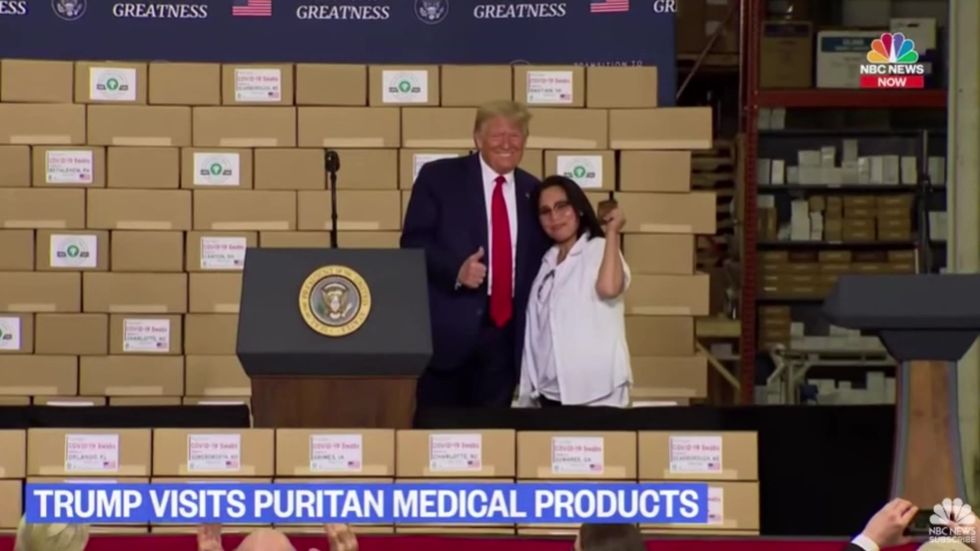 Trump ignores social distancing to pose with Puritan Medical Products worker