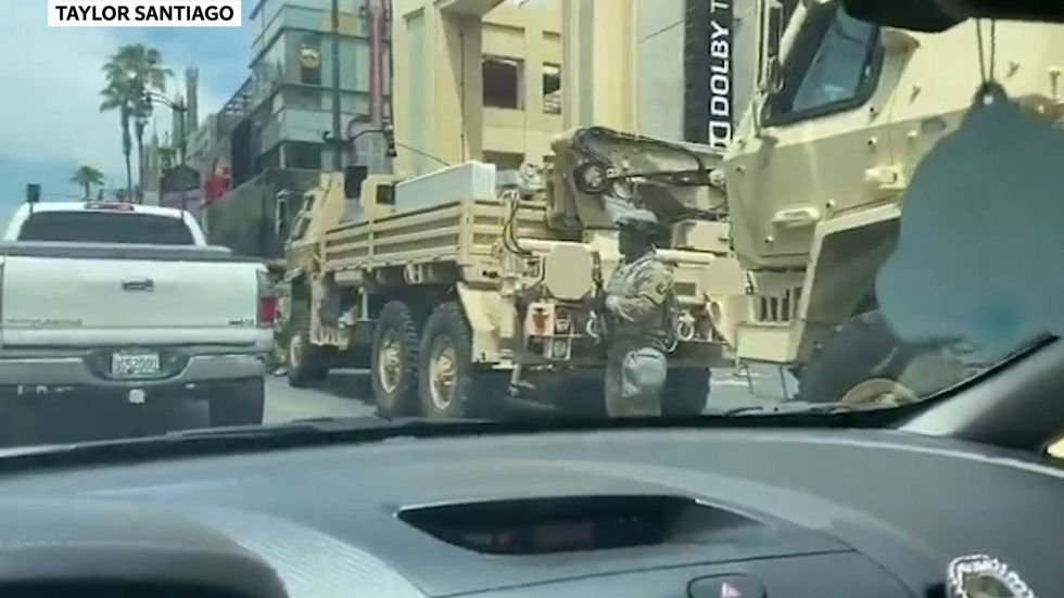 Military trucks line Hollywood Boulevard