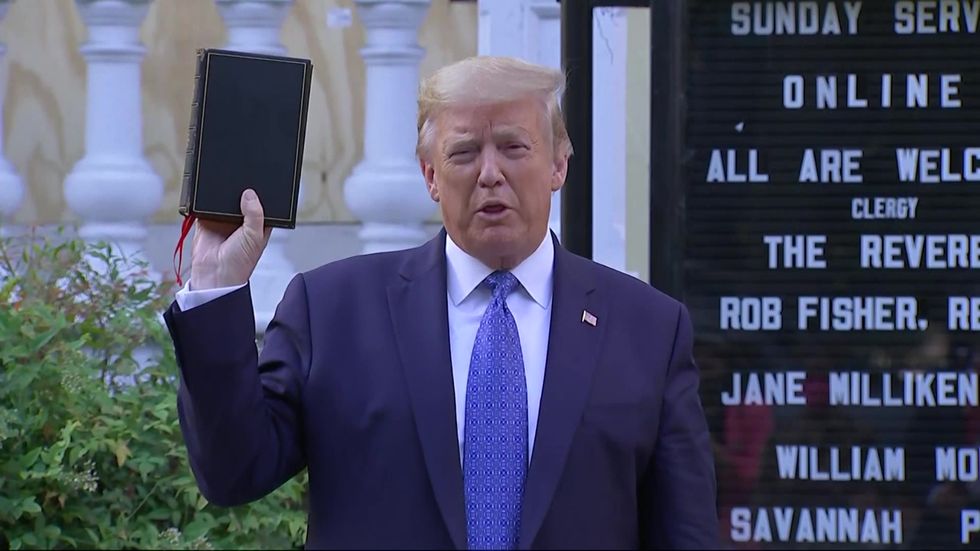 Trump holds up bible outside Washington church