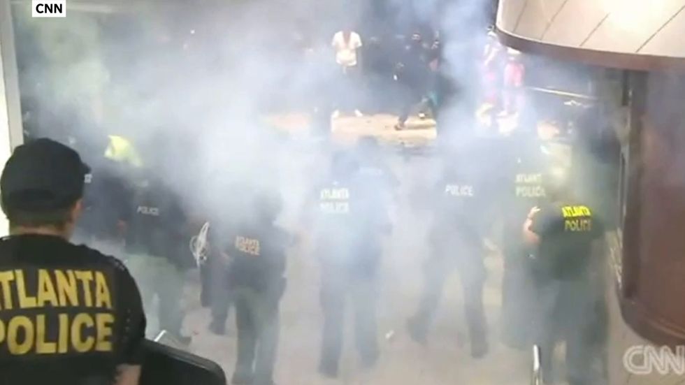 Object explodes as protesters batter CNN building in Atlanta