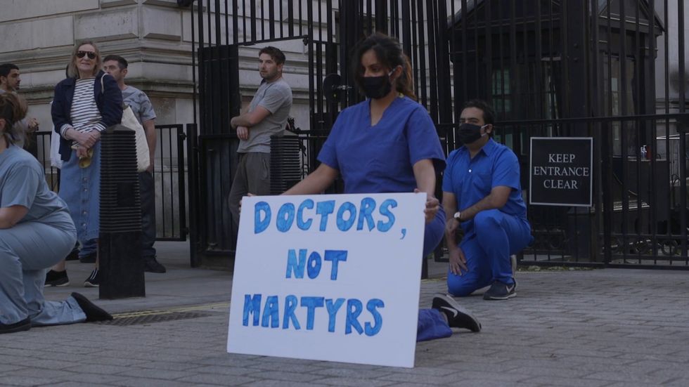 NHS staff protest outside Downing Street during Clap for Carers