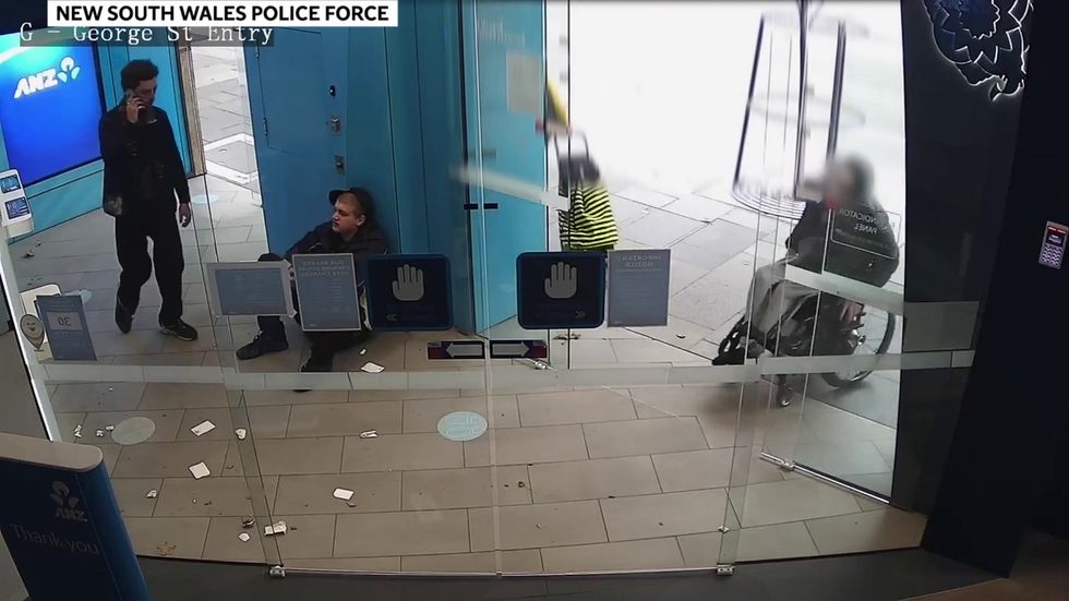 Two men snatch money from a wheelchair user before running away in Sydney