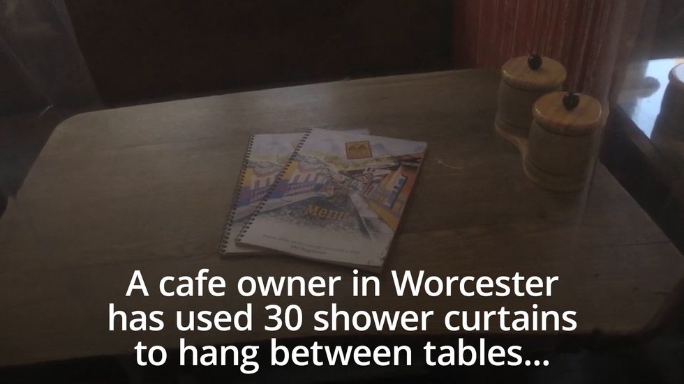 Cafe owner uses shower curtains for social distancing