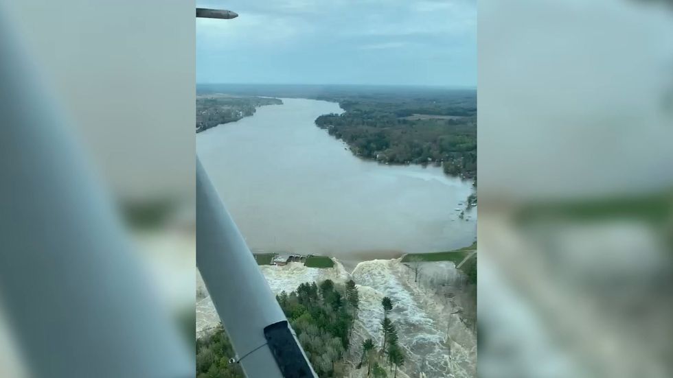 Aerial view of burst dam in Michigan as 10,000 people are evacuated
