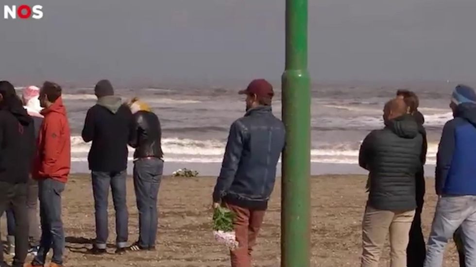Beach-goers pay their respects after five surfers die in ‘foam avalanche’ in Netherlands