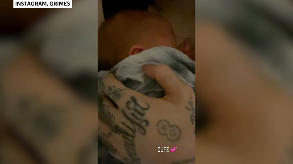Grimes shares new videos cradling baby X Æ A-12
