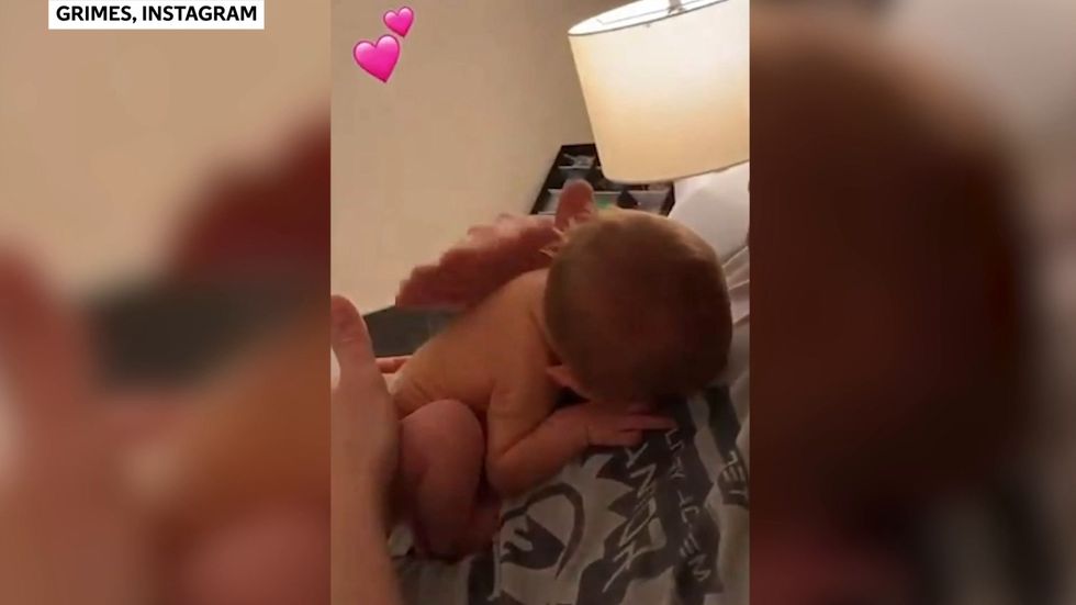 Grimes shares video of Elon Musk cuddling tiny newborn son X Æ A-12