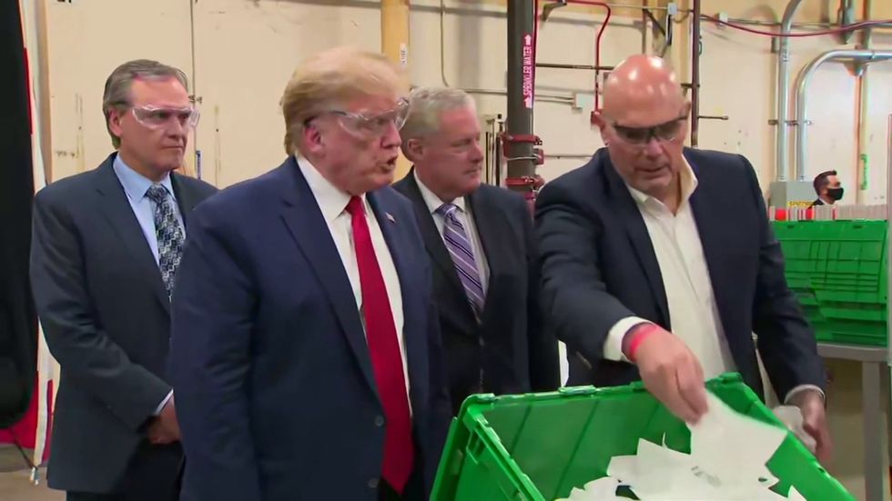 ‘Live and let die’ blasts as Trump tours face mask factory without wearing mask