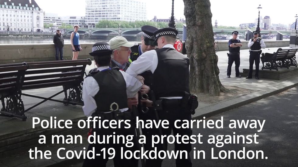 Man carried away by police during anti-lockdown protest in London