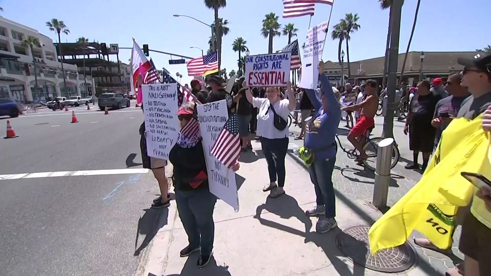 Large crowds gather to protest beach closures in California
