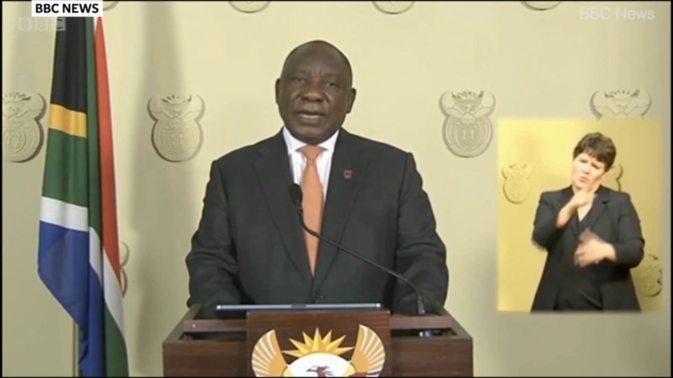 South African president Cyril Ramaphosa struggles to put on face mask
