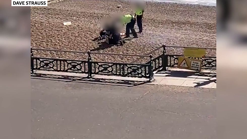 Police pour helmet full of water over BBQ after beach-goers 'refuse to leave' during lockdown