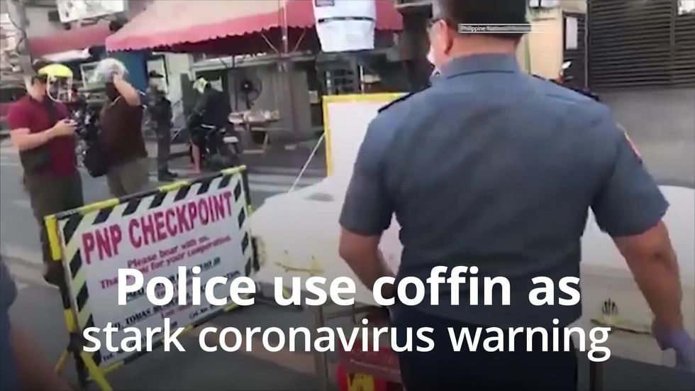 Police in the Philippines install a coffin at checkpoint during Covid-19 pandemic