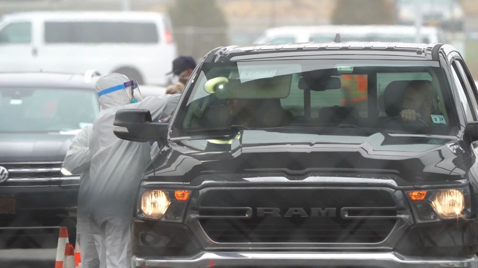 People queue for drive-thru coronavirus testing on Staten Island, New York