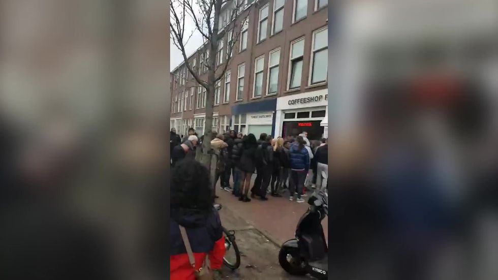 People queue outside 'Coffee Shop' in Netherlands before coronavirus closures