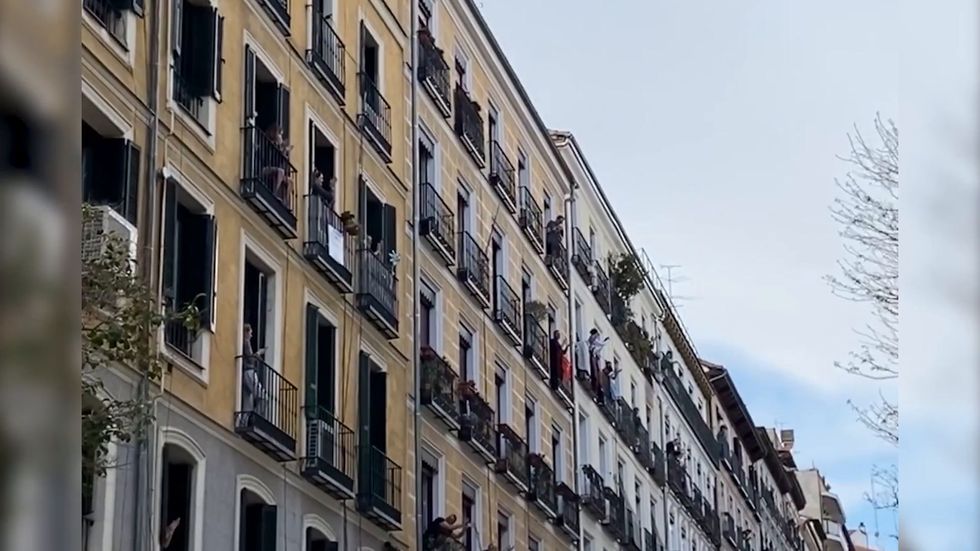 People in Madrid sing and dance together from their balconies amid lockdown