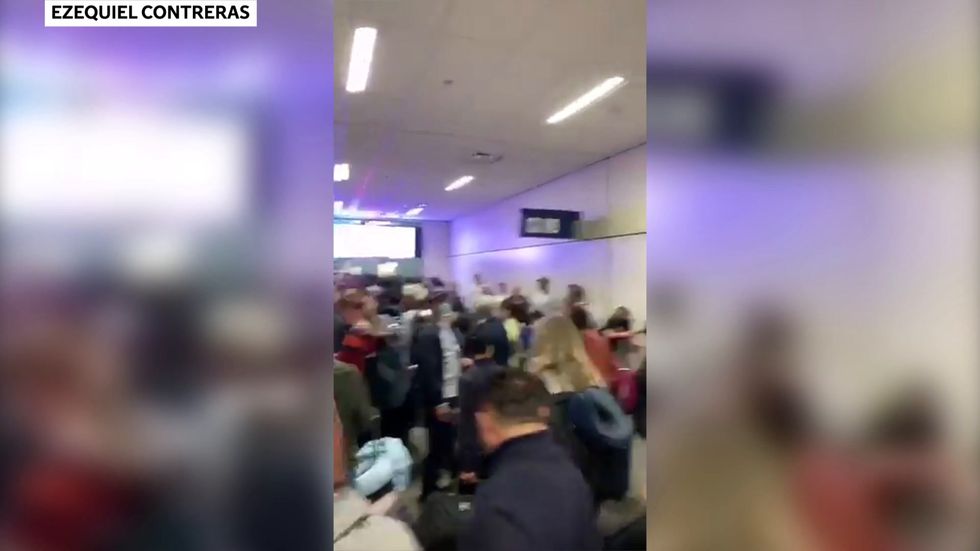 People wait in line to go through the customs at Dallas Fort Worth International Airport
