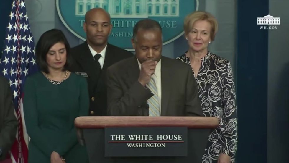 Ben Carson coughs into his hand then touches his face seconds later