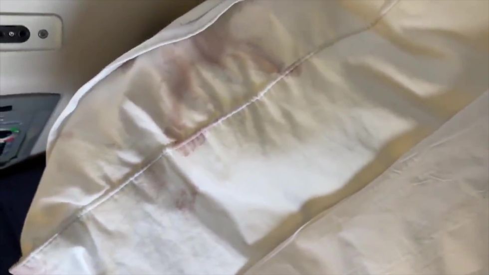 Tinie Tempah spots stained pillow while wiping down British Airways seat