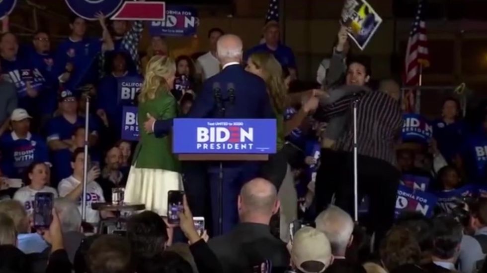 Joe Biden's adviser wrestles protesters off stage