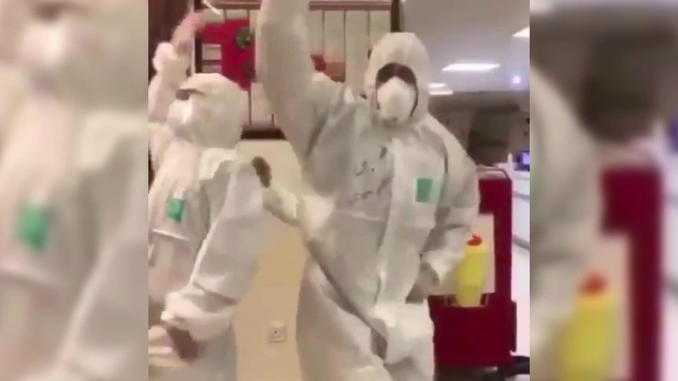 Medical staff in Iran dance in protective suits and masks