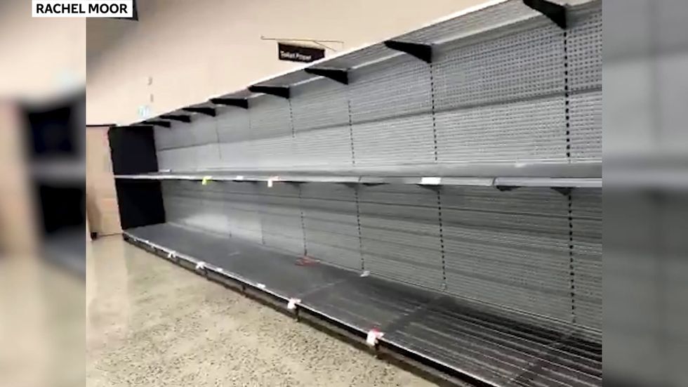 Coronavirus: Supermarket shelves left empty by panic buying in Australia