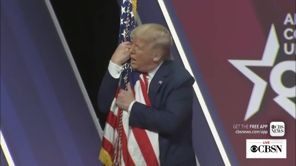 Trump kisses a flagpole at CPAC while Coronavirus fears grip nation