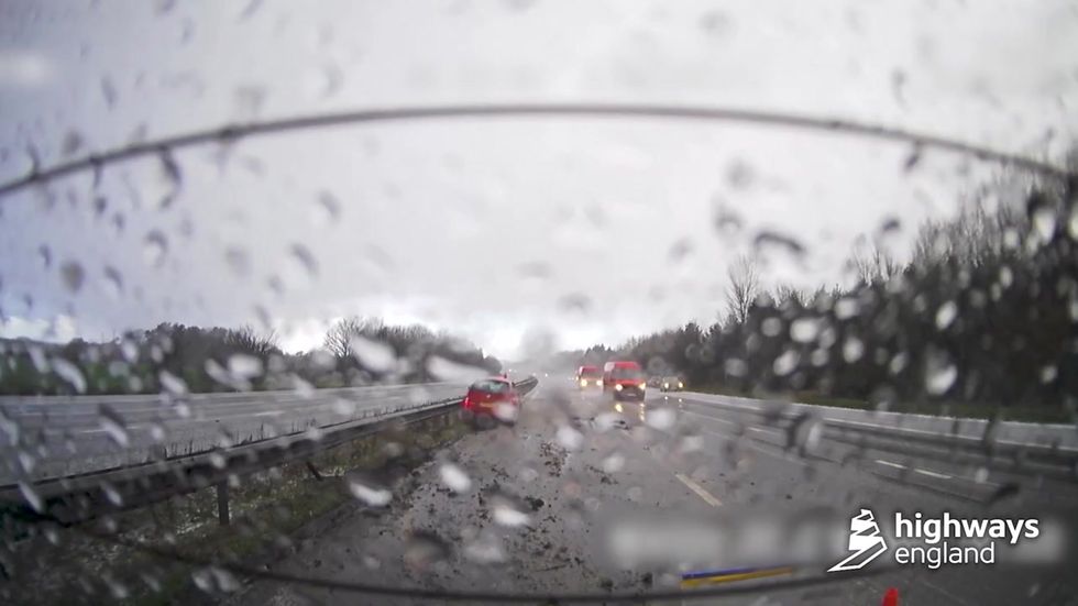 Driver loses control of car and skids backwards down sleet-covered motorway