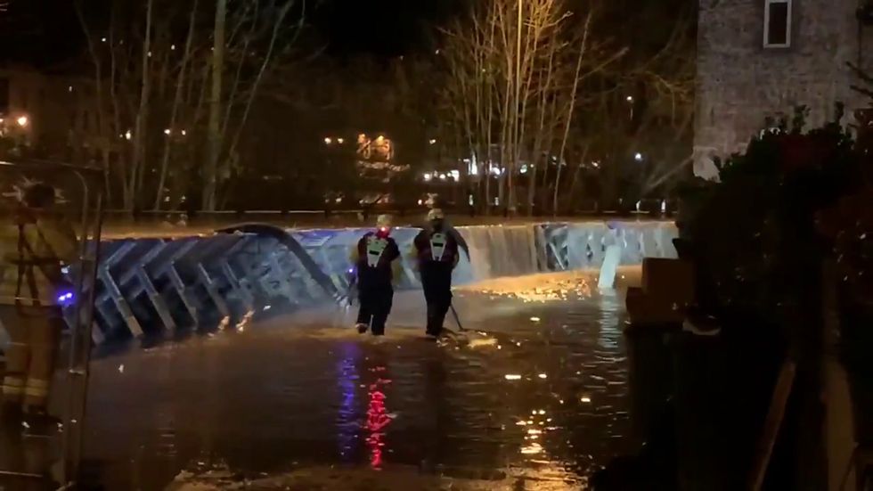Water pours over flood defences in Bewdley, Worcestershire
