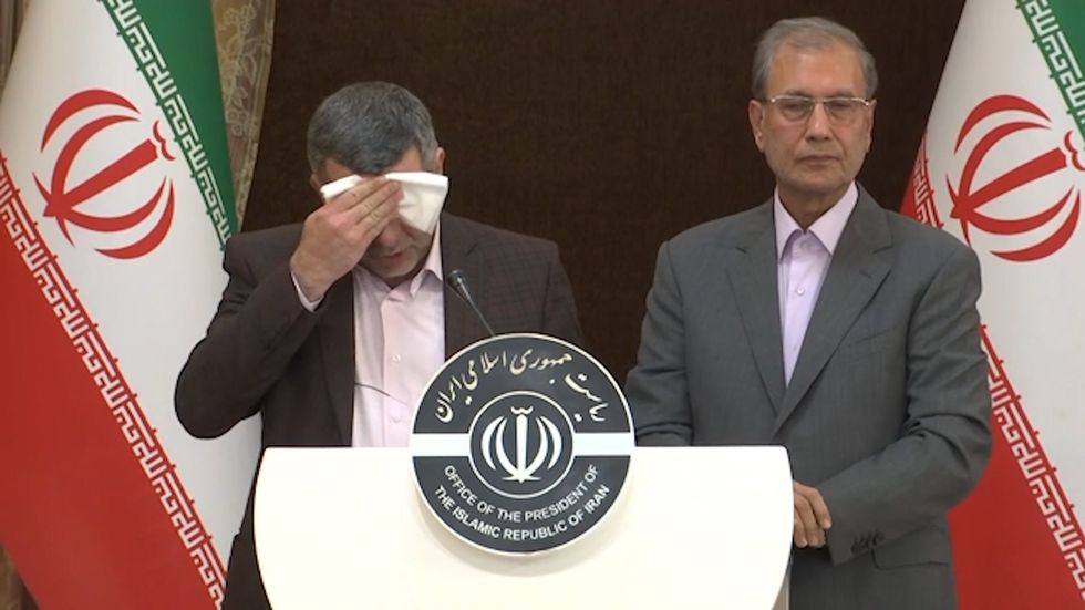 Iran's deputy health minister looks unwell as he mops his brow just before testing positive for Coronavirus