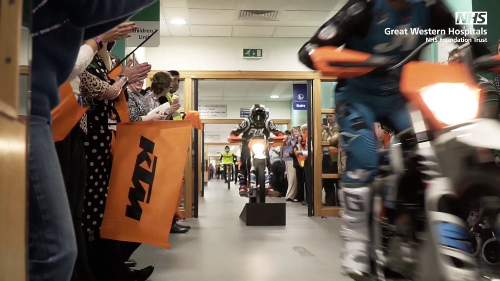 Motorcyclists whiz down hospital corridors with kids
