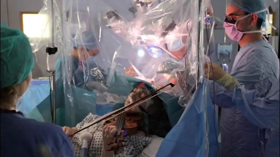 Patient plays violin while undergoing brain surgery