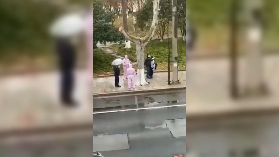 Video from China shows screaming woman being placed in metal box by quarantine workers
