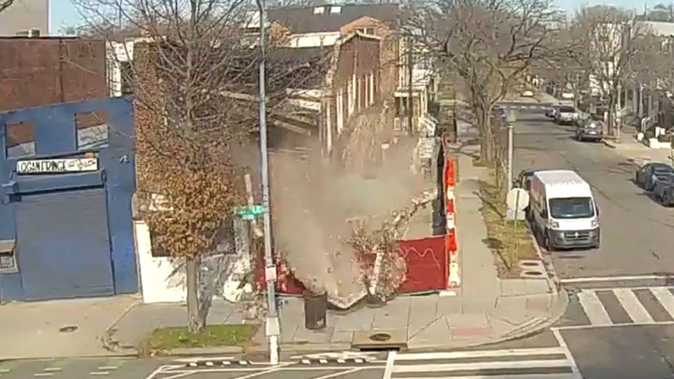 Security camera captures building 'randomly collapsing'