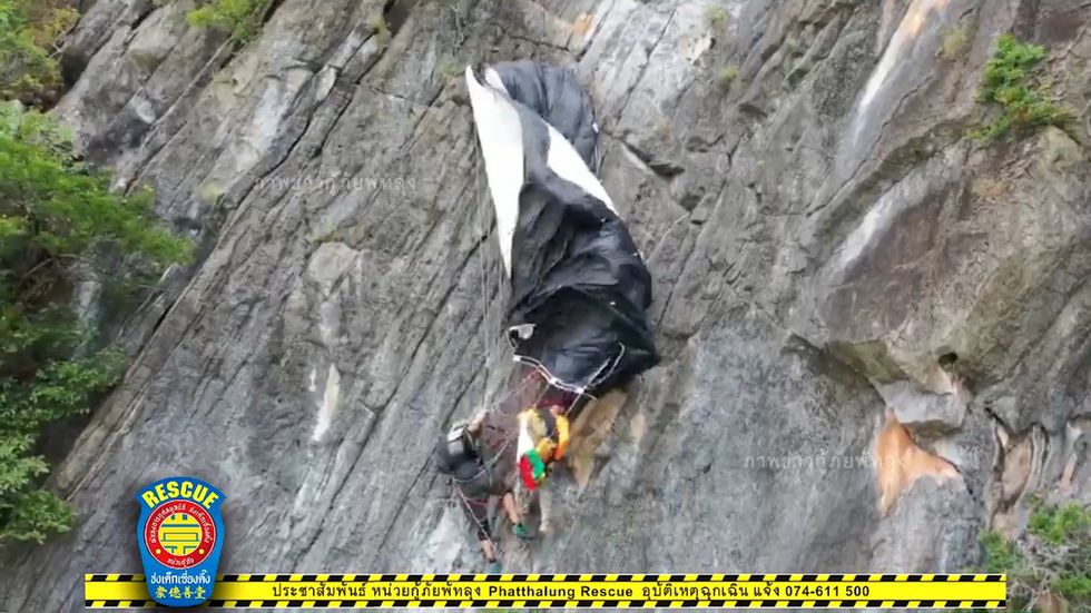 Moment Austrian man dangling from cliff rescued after parachute accident in Thailand